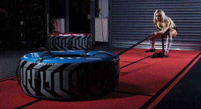 Fitness training tyre in blue and black with a tread pattern and handles, shown with Inside Diameter 20"