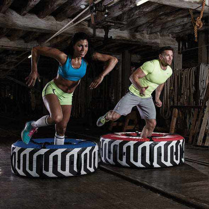 Training tyre with handles, featuring a black and white geometric pattern and red top accents; Outside Diameter 34